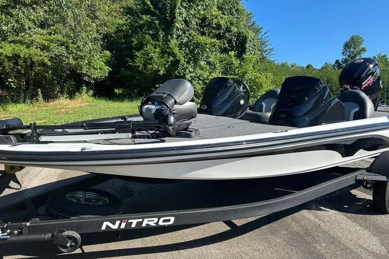 Slide: The Image of 2026 Nitro Z17 boat on trailer, surrounded by lush greenery. - 1