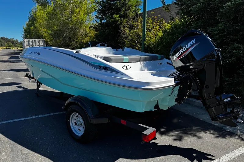Slide: The Image of 2026 Tahoe T16 boat with Mercury engine, parked outdoors on a trailer. - 4