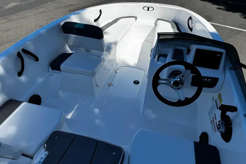 Slide: The Image of 2026 Tahoe T16 boat interior with steering wheel, seating, and control panel. - 7