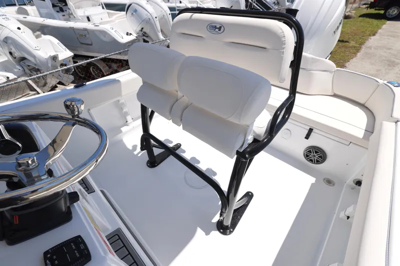 Slide: The Image of 2026 Sea Hunt Ultra 219 boat interior with steering wheel and seating. - 13