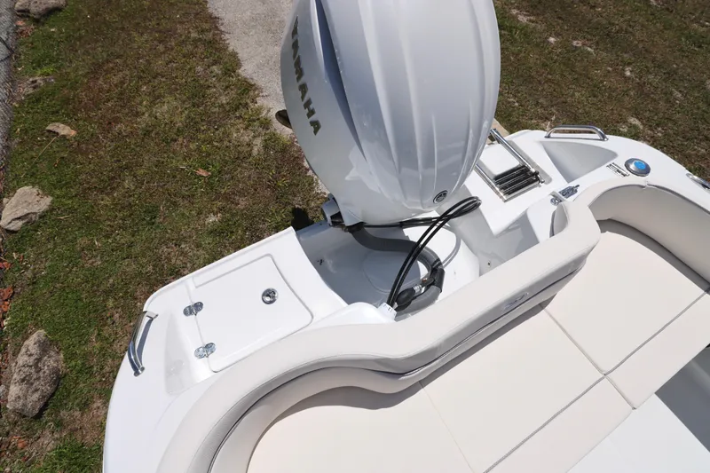 Slide: The Image of 2026 Sea Hunt Ultra 219 boat with Yamaha outboard engine, featuring sleek white seating and deck. - 14