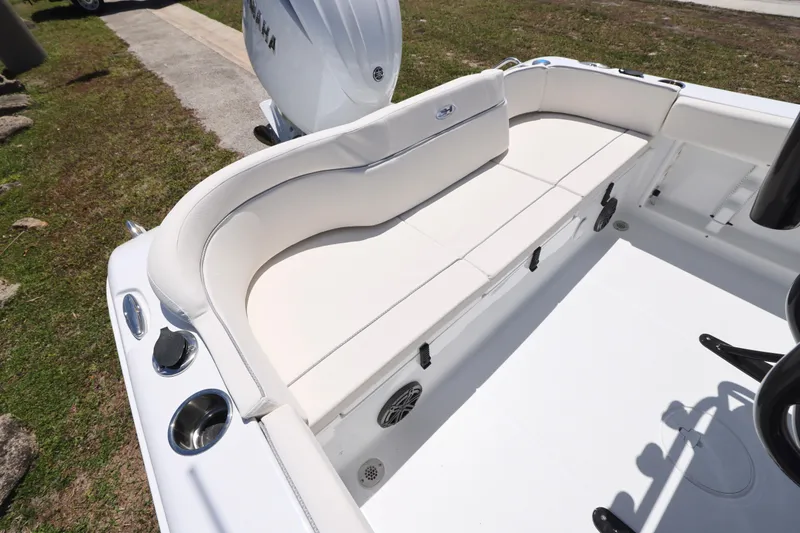 Slide: The Image of 2026 Sea Hunt Ultra 219 boat with white cushioned seating and Yamaha engine. - 3