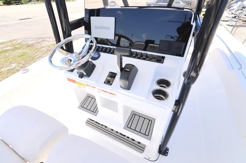 Slide: The Image of 2026 Sea Hunt Ultra 219 boat console with Garmin navigation system and steering wheel. - 9
