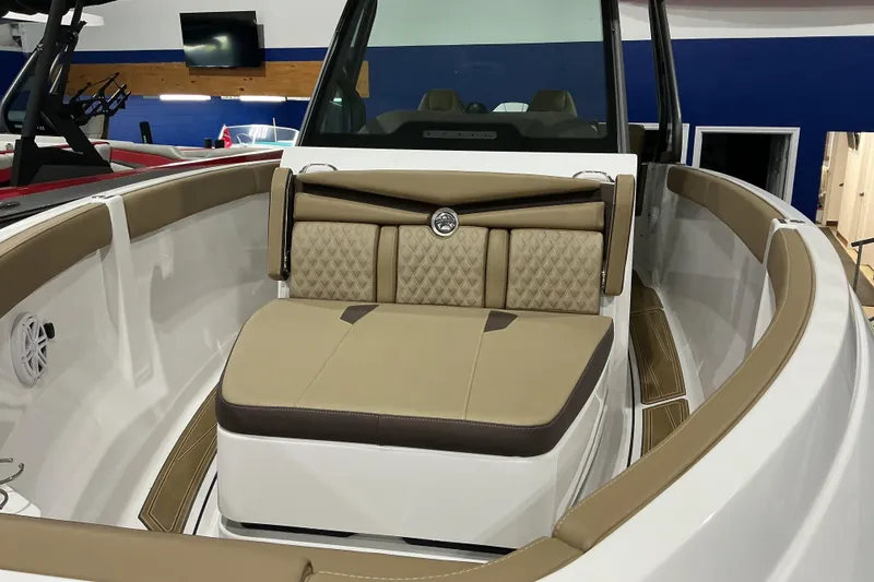Slide: The Image of Luxurious interior of 2026 Monterey Elite 25 OB boat with tan seating and modern design. - 11