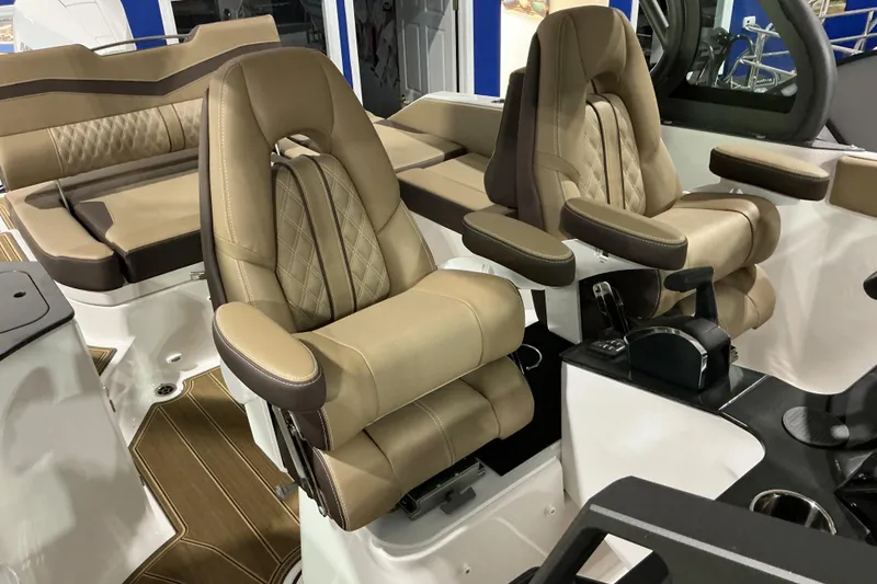 Slide: The Image of Luxurious seating on the 2026 Monterey Elite 25 OB boat, featuring plush tan upholstery. - 14