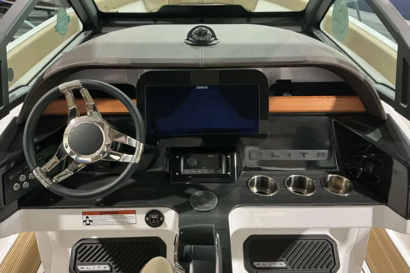 Slide: The Image of Dashboard of 2026 Monterey Elite 25 OB boat with modern steering and controls. - 15