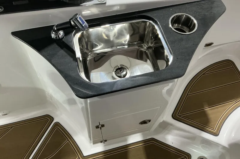 Slide: The Image of 2026 Monterey Elite 25 OB boat sink with faucet and cup holder. - 17