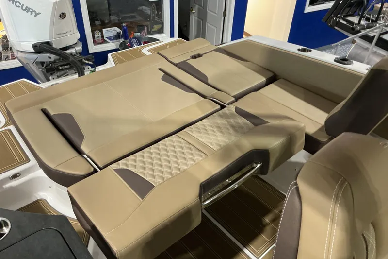 Slide: The Image of Luxurious seating on 2026 Monterey Elite 25 OB boat, featuring tan upholstery and modern design. - 19