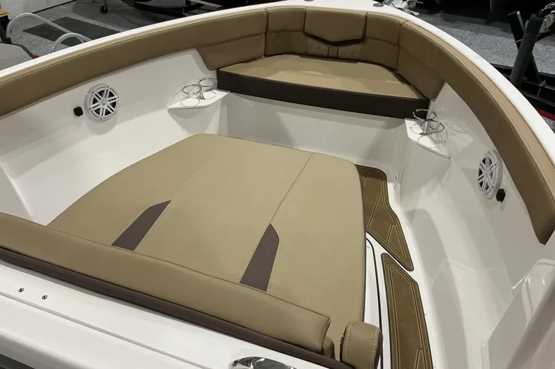 Slide: The Image of Luxurious seating area of 2026 Monterey Elite 25 OB boat with cup holders and speakers. - 22