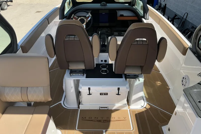 Slide: The Image of Interior of 2026 Monterey Elite 25 OB boat with luxurious seating and modern dashboard. - 9