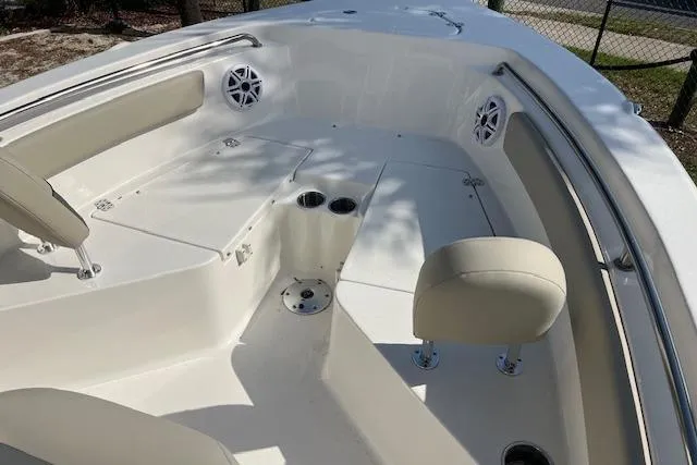 Slide: The Image of 2026 Key West 203 FS boat interior with seating, cup holders, and speakers. - 10