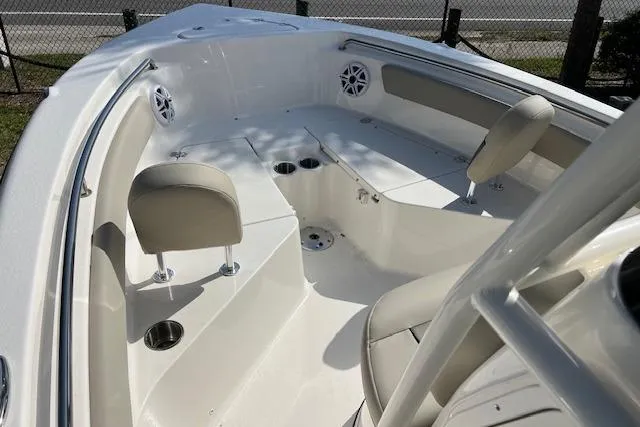 Slide: The Image of 2026 Key West 203 FS boat interior with seating, cup holders, and speakers. - 9