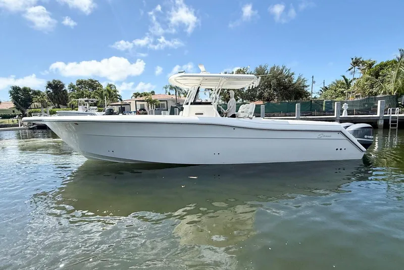 Slide: The Image of 2014 Stamas 390 Tarpon boat on calm water, clear sky background. - 11