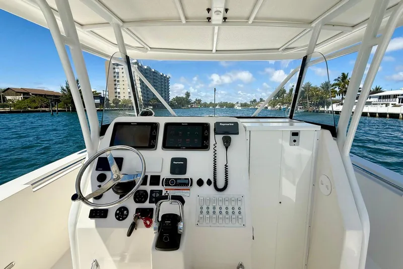 Slide: The Image of 2014 Stamas 390 Tarpon boat helm with navigation equipment on a sunny day. - 14