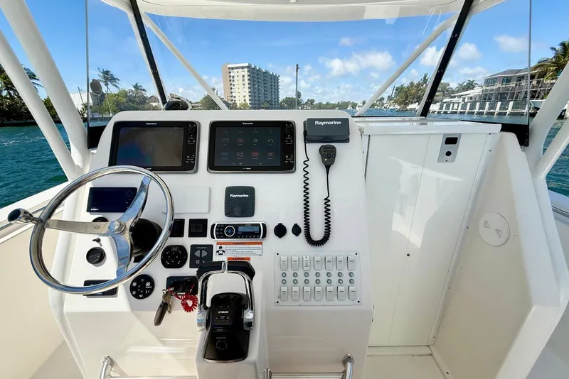 Slide: The Image of 2014 Stamas 390 Tarpon boat dashboard with steering wheel and Raymarine electronics. - 15