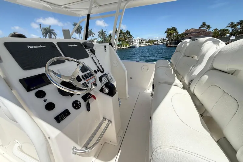 Slide: The Image of 2014 Stamas 390 Tarpon boat interior with steering console and plush seating. - 18