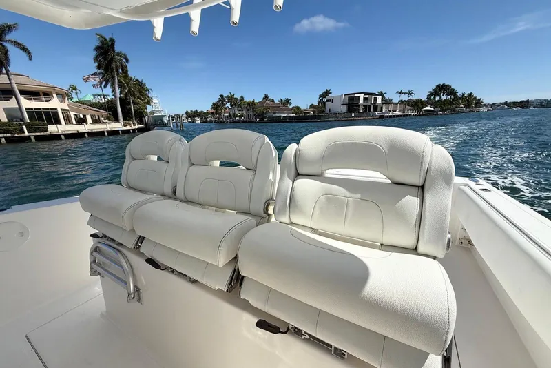 Slide: The Image of 2014 Stamas 390 Tarpon boat with white seating, cruising on a sunny waterfront. - 19