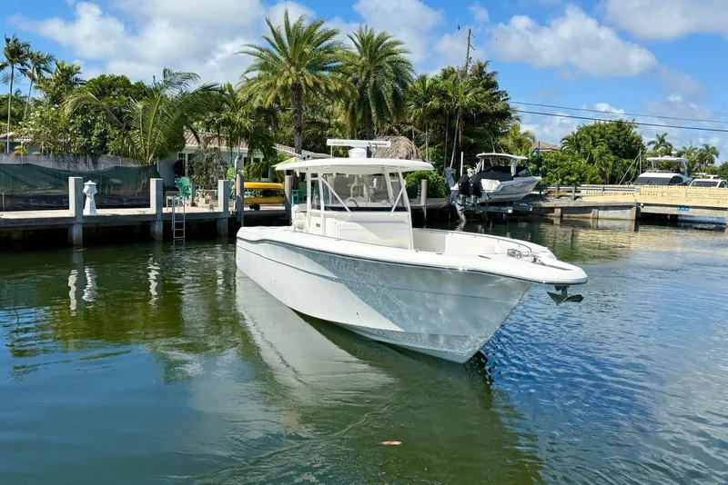 Slide: The Image of 2014 Stamas 390 Tarpon boat docked in a tropical marina setting. - 2