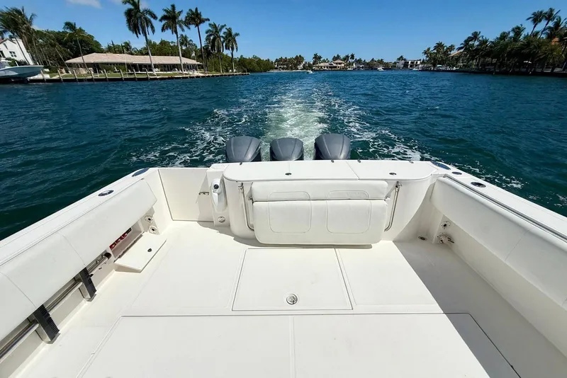 Slide: The Image of 2014 Stamas 390 Tarpon boat cruising on a sunny day with palm trees in the background. - 21