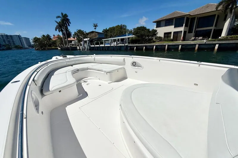Slide: The Image of 2014 Stamas 390 Tarpon boat with spacious seating, docked near waterfront homes. - 26