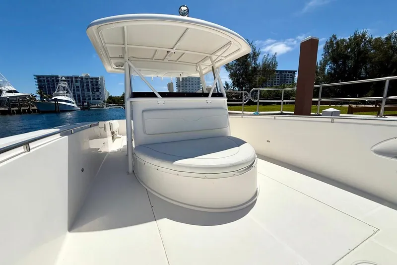 Slide: The Image of 2014 Stamas 390 Tarpon boat with spacious seating, docked near waterfront buildings. - 28