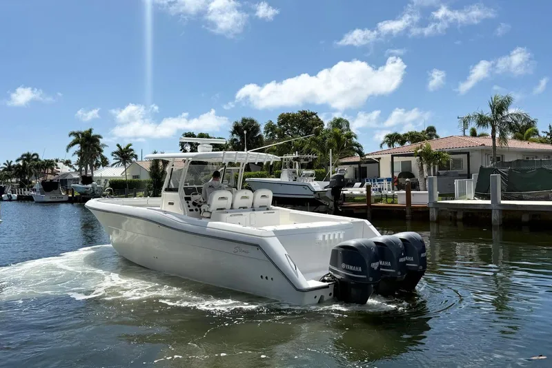 Slide: The Image of 2014 Stamas 390 Tarpon boat with Yamaha engines on a sunny waterfront. - 3