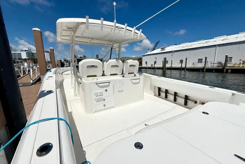 Slide: The Image of 2014 Stamas 390 Tarpon boat docked, featuring spacious seating and sleek design under a clear sky. - 31
