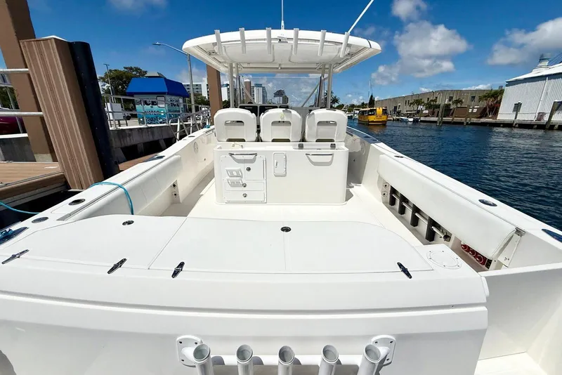 Slide: The Image of 2014 Stamas 390 Tarpon boat docked, featuring spacious deck and seating under clear skies. - 32