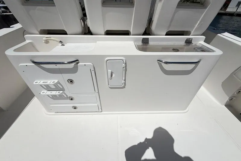 Slide: The Image of 2014 Stamas 390 Tarpon boat interior with storage compartments and sink. - 34