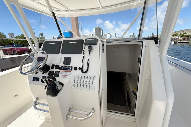 Slide: The Image of 2014 Stamas 390 Tarpon boat cockpit with steering wheel and navigation equipment. - 35