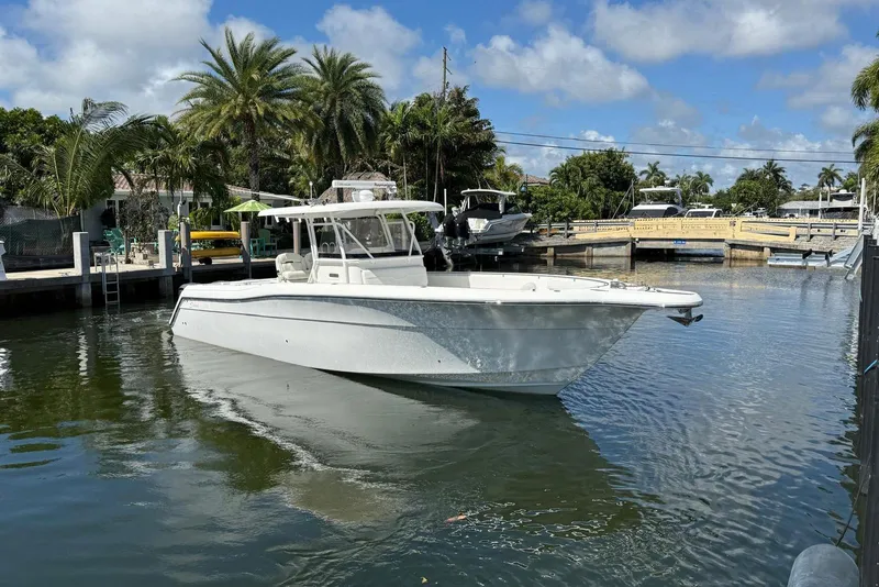 Slide: The Image of 2014 Stamas 390 Tarpon boat docked in a tropical marina setting. - 4