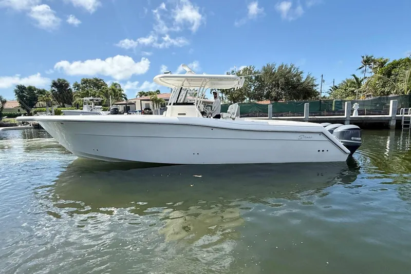 Slide: The Image of 2014 Stamas 390 Tarpon boat on calm water, clear sky background. - 5