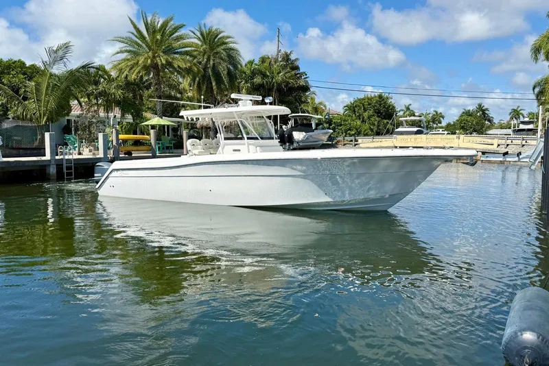 Slide: The Image of 2014 Stamas 390 Tarpon boat docked in a tropical marina setting. - 7