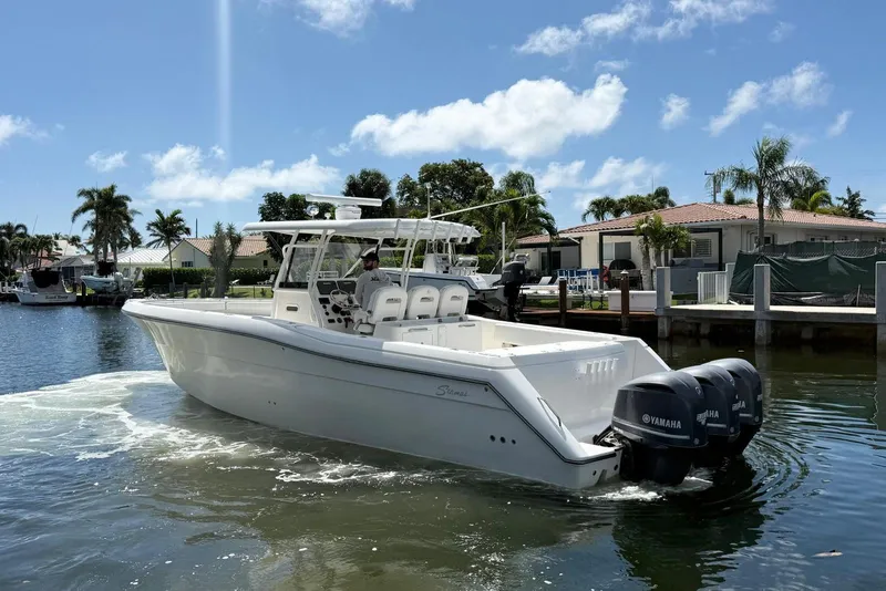 Slide: The Image of 2014 Stamas 390 Tarpon boat with Yamaha engines on a sunny day in a canal. - 8