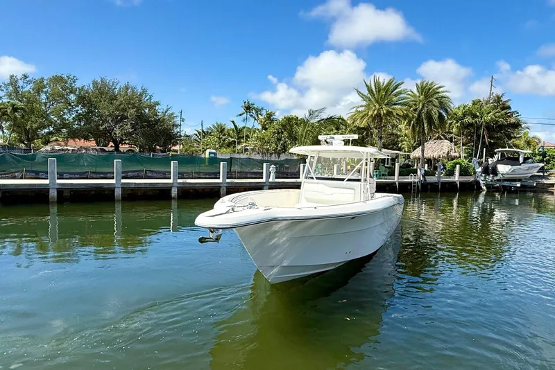 Slide: The Image of 2014 Stamas 390 Tarpon boat docked in a scenic marina setting. - 9