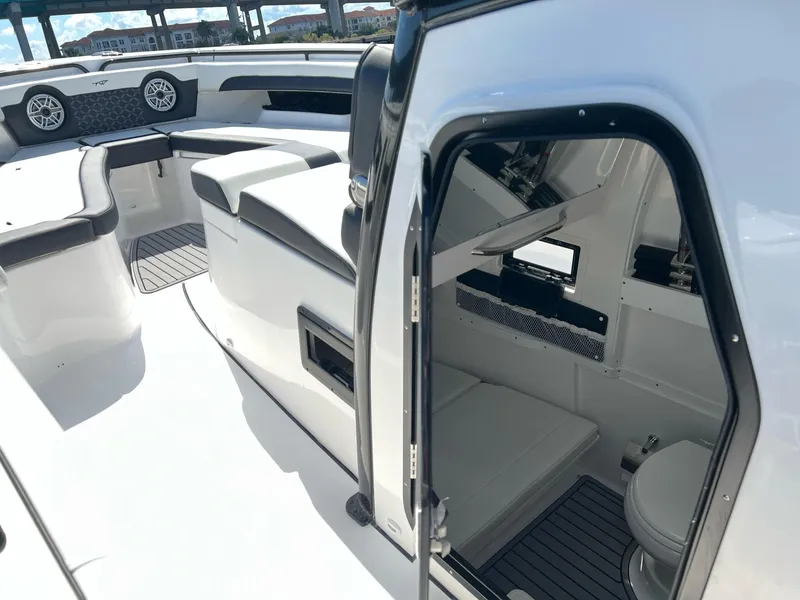 Slide: The Image of 2023 Tidewater 320 CC Adventure boat interior with seating and cabin view. - 13