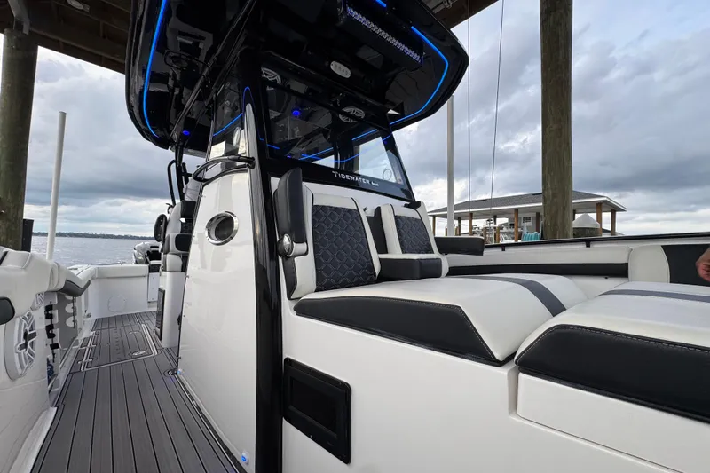 Slide: The Image of 2023 Tidewater 320 CC Adventure boat interior with sleek seating and modern design. - 19