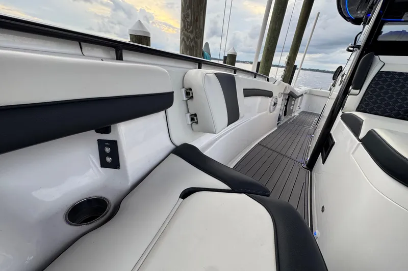 Slide: The Image of 2023 Tidewater 320 CC Adventure boat interior with sleek seating and modern design. - 23