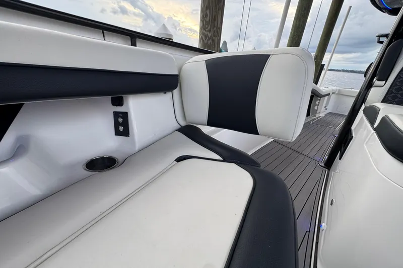Slide: The Image of 2023 Tidewater 320 CC Adventure boat interior with cushioned seating and sleek design. - 24
