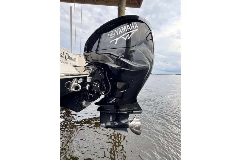 Slide: The Image of Yamaha outboard motor on 2023 Tidewater 320 CC Adventure boat, docked by the water. - 28