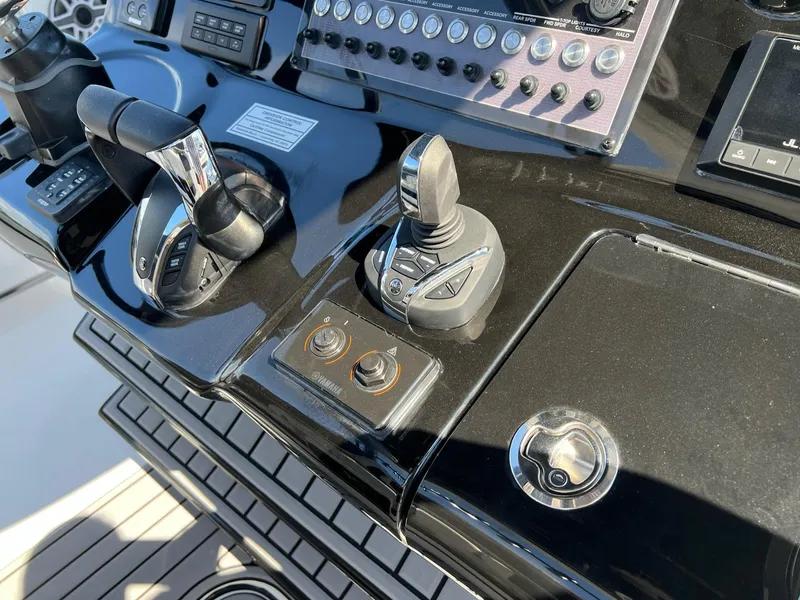 Slide: The Image of Control panel of 2023 Tidewater 320 CC Adventure boat with joystick and throttle. - 9