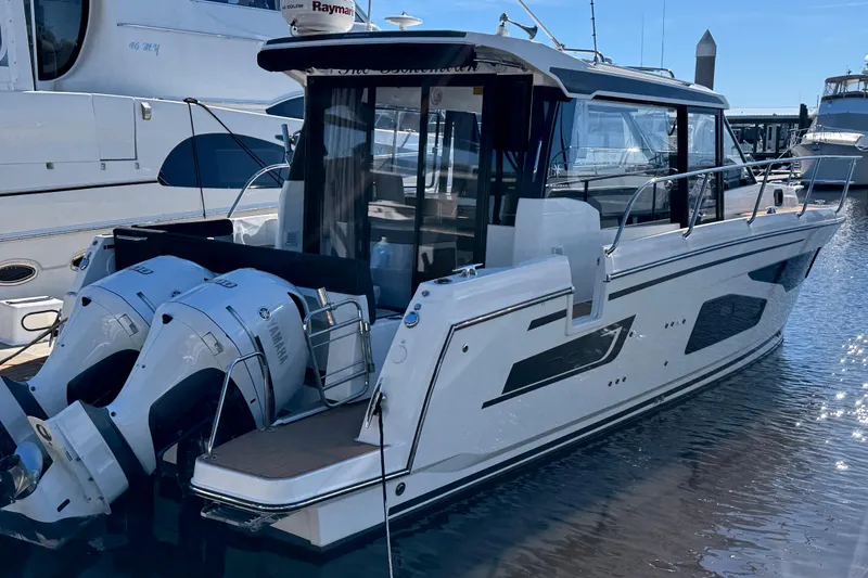 Slide: The Image of 2021 Jeanneau NC Weekender 1095 boat with dual Yamaha outboard engines docked at marina. - 4