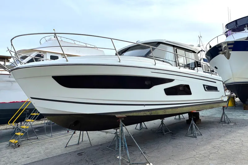 Slide: The Image of 2021 Jeanneau NC Weekender 1095 boat on stands in a marina. - 7