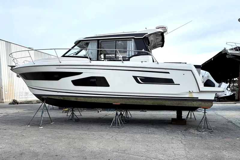 Slide: The Image of 2021 Jeanneau NC Weekender 1095 boat on stands in a marina. - 8