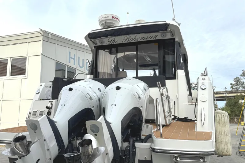 Slide: The Image of 2021 Jeanneau NC Weekender 1095 boat with dual outboard engines, docked at marina. - 9