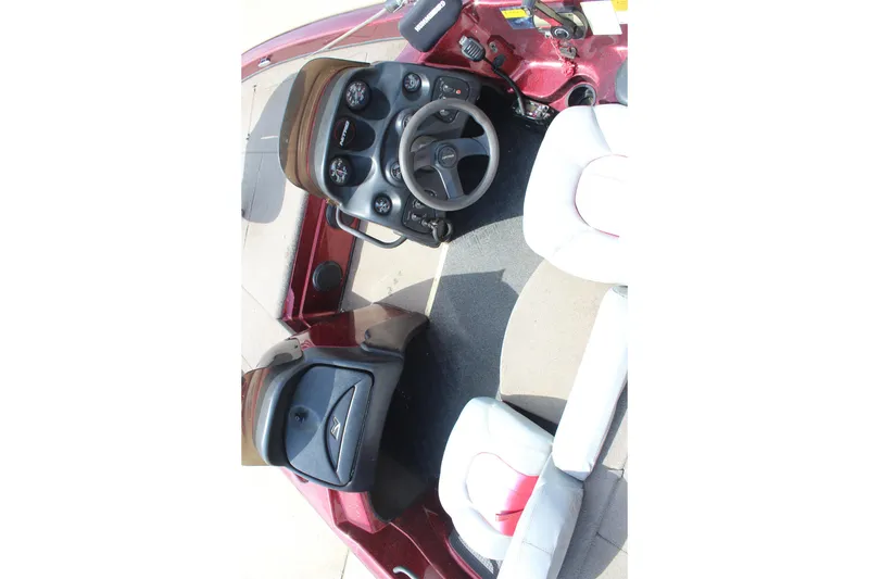 Slide: The Image of Interior view of a 2002 Nitro NX 882 DC boat, featuring steering wheel and seating. - 15
