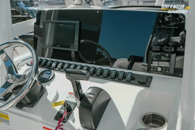 Slide: The Image of 2021 Sea Hunt Ultra 229 boat dashboard with steering wheel and control panel. - 17