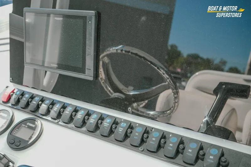 Slide: The Image of Dashboard of 2021 Sea Hunt Ultra 229 boat with Garmin display and controls. - 18