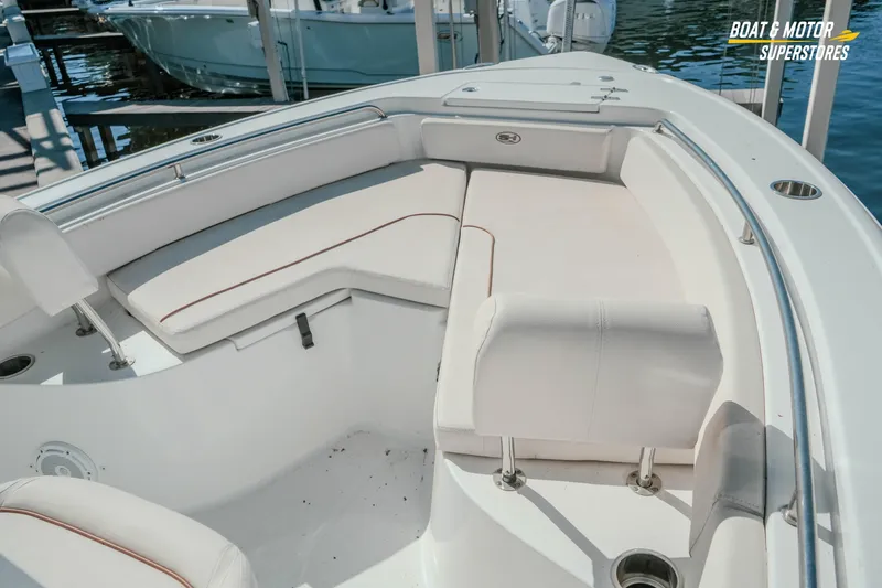 Slide: The Image of 2021 Sea Hunt Ultra 229 boat interior with white cushioned seating and stainless steel railings. - 20