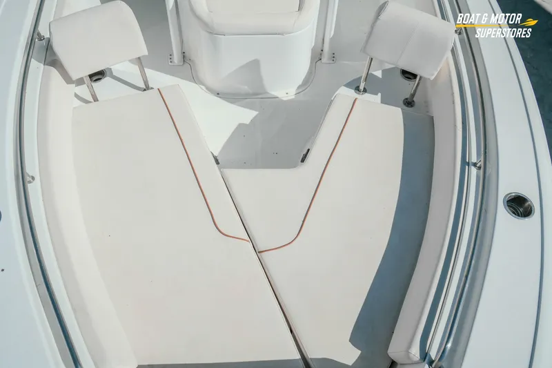 Slide: The Image of 2021 Sea Hunt Ultra 229 boat interior with cushioned seating and storage compartments. - 21